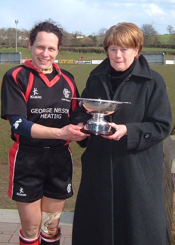 Suzanne Fleming receives the cup from Rosie's mother. 